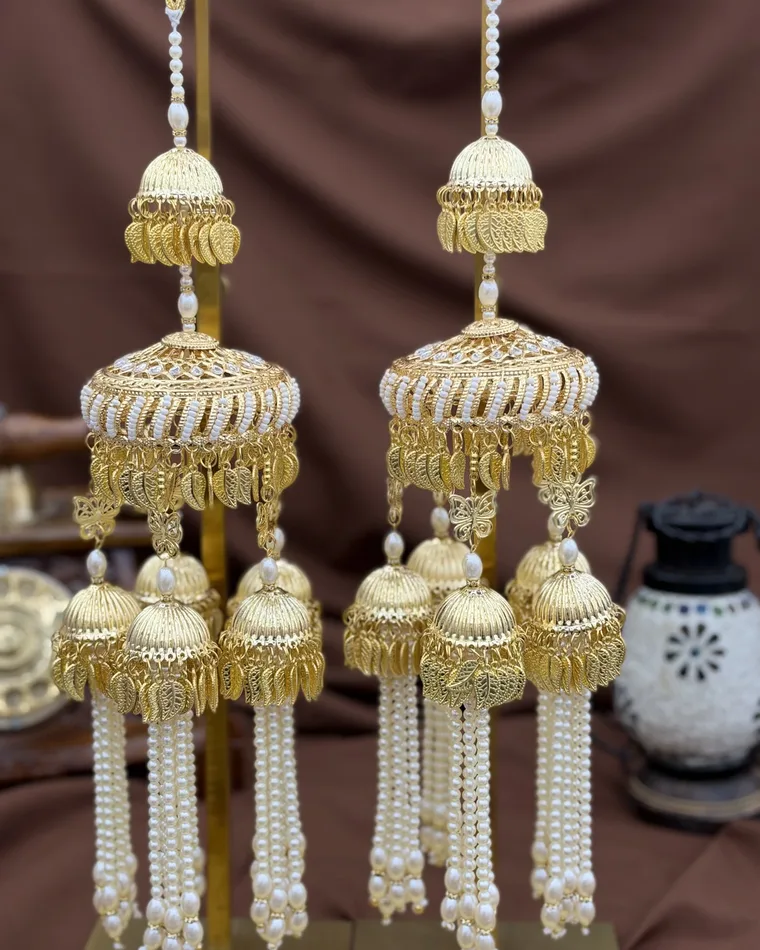 Traditional gold pearl kaleera set with butterfly and leaf jhumki charms and pearl tassels — bridal kalire Calgary