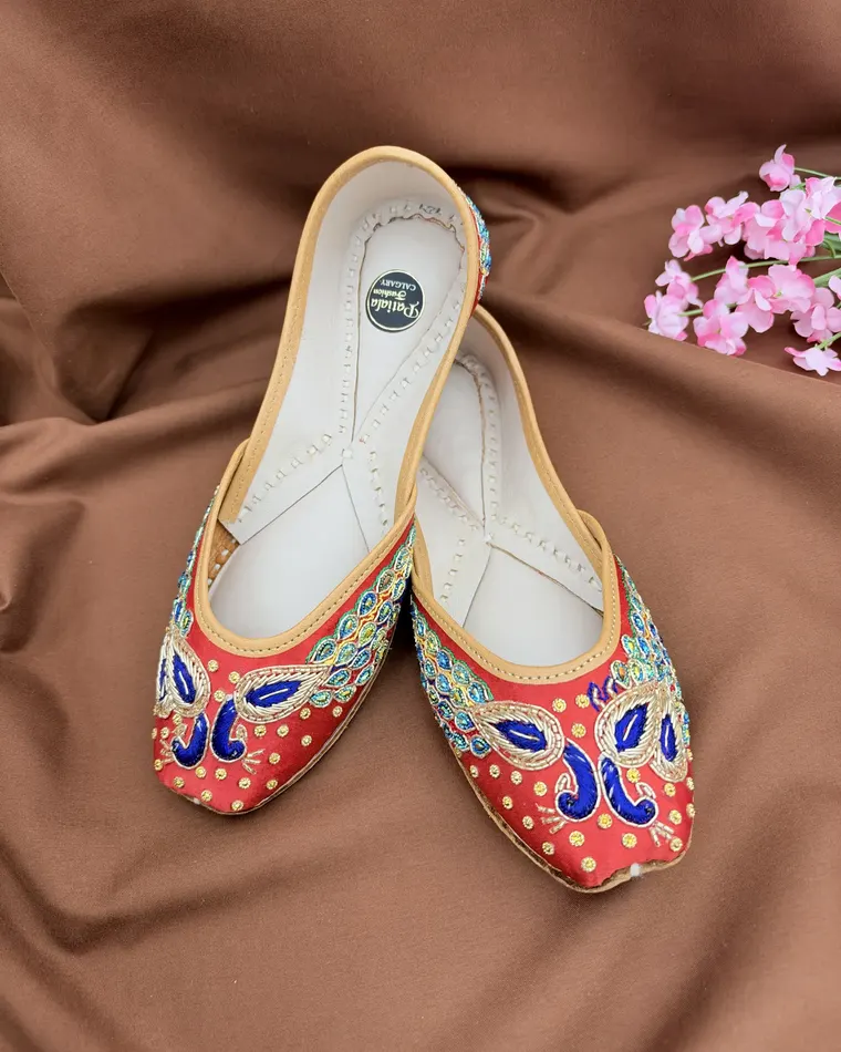 Red and gold peacock embroidered Punjabi jutti with blue threadwork — women's jutti Calgary